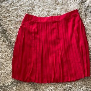 Red pleated mini skirt